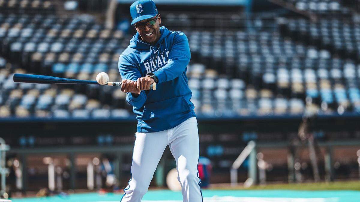 Kansas City Royals infield coach José Alguacil bats ground balls to KC players before a game.