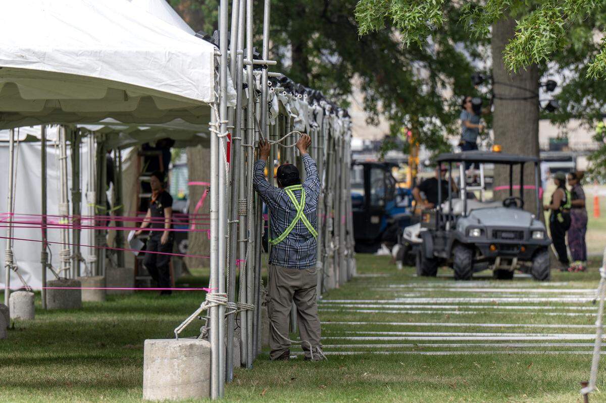 An event staffer sets up tents outside the National WWI Museum and Memorial on Tuesday, Sept. 30, 2025 in Kansas City, ahead of pop singer Chappell Roan's concert Visions of Damsels and Other Dangerous Things.