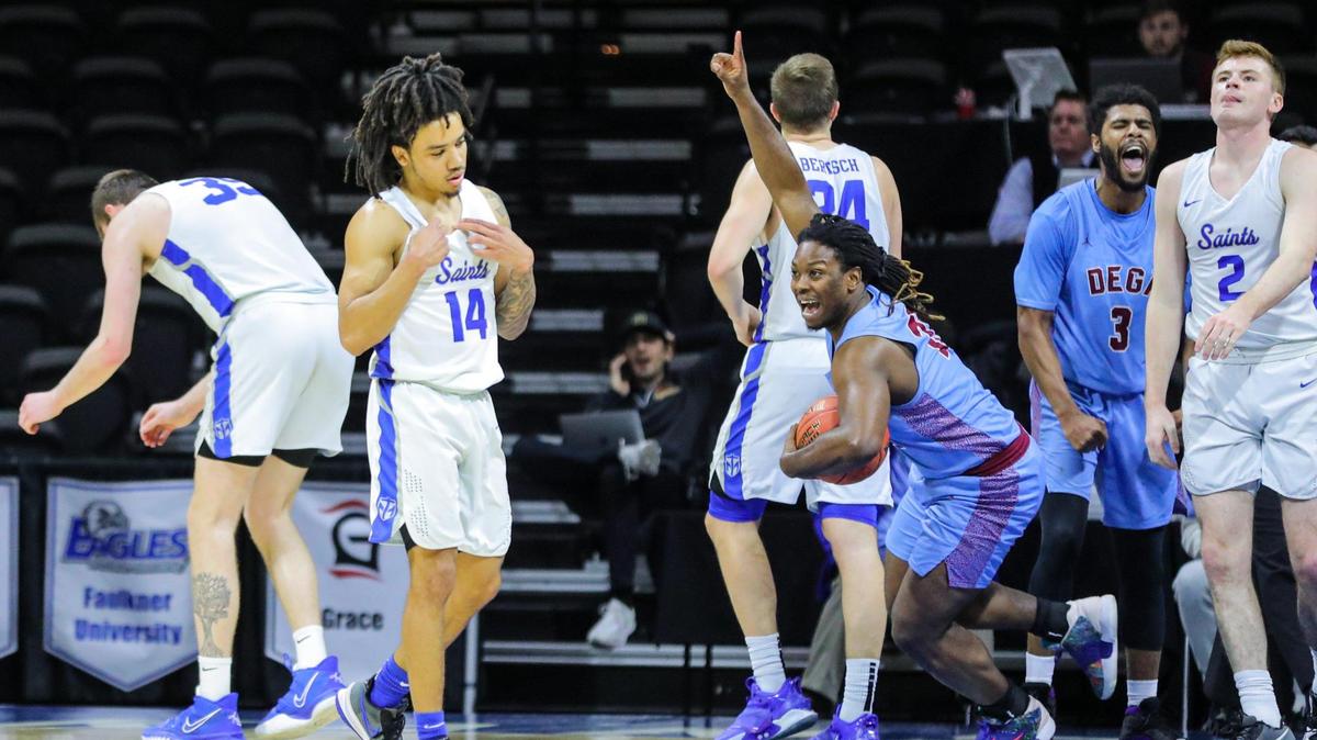 Richard Boggan, right with ball, begins celebrating Talladega’s 78-77 overtime win as Jacob Jones, left, reacts to the Saints missing a couple of chances to win Monday night in the 2022 NAIA Men’s Basketball National Championship seminfinal at Municipal Auditorium. Talladege will face Loyola (La.) in Tuesday’s final.