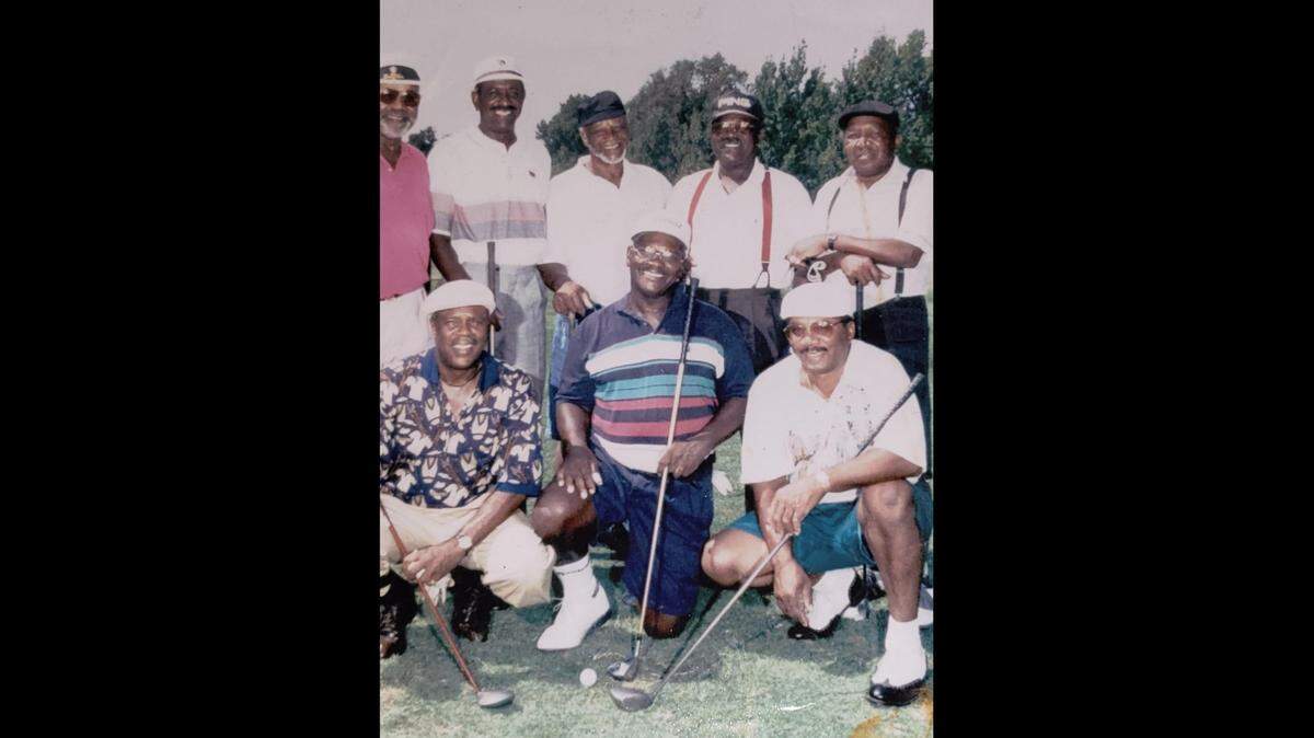 Joe Hubbard posing with golf buddies.