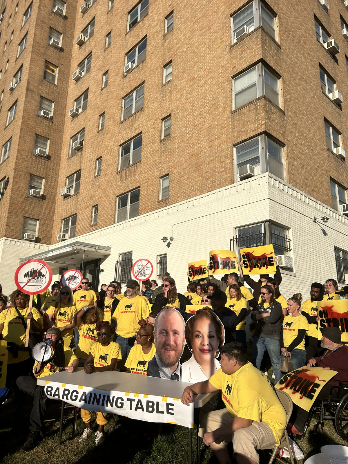 Residents at Indpendence Towers and Quality Hills gathered around a mock “bargaining table” on Oct. 18 as they marked 18 days of withholding more than $60,000 in rent.