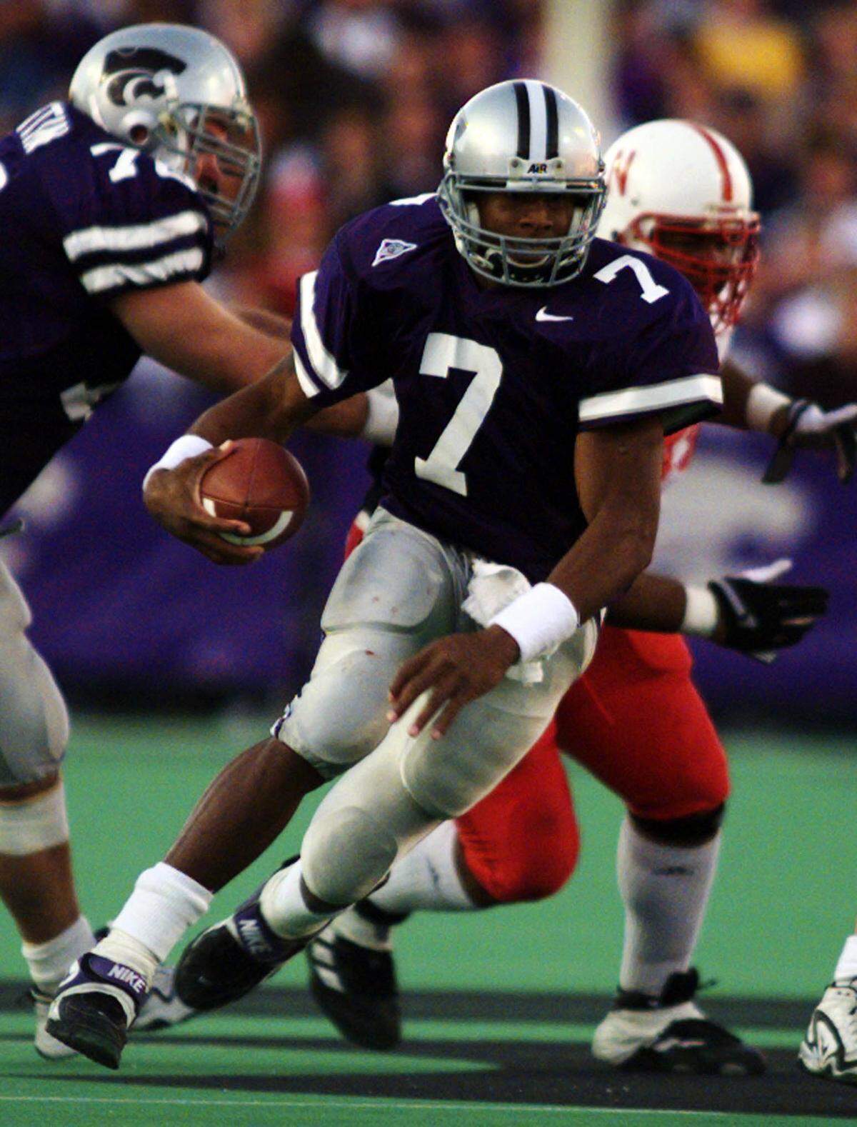 Kansas State quarterback Michael Bishop slips through the Nebraska defensive line and heads for a first down during their Saturday Nov. 14, 1998 game in Manhattan, Kan.