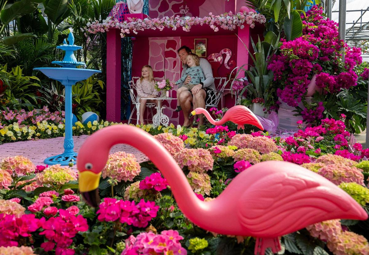 Malia Anderson of Prairie Village takes photos with her children, Lily, 7, and Finn, 3, at Family Tree Nursery’s Barbie display.