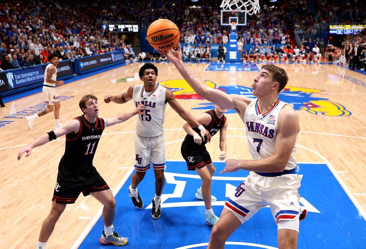 Kohl Rosario #7 of the Kansas Jayhawks drives to the basket during the game against the Davidson Wildcats at Allen Fieldhouse on December 22, 2025 in Lawrence.