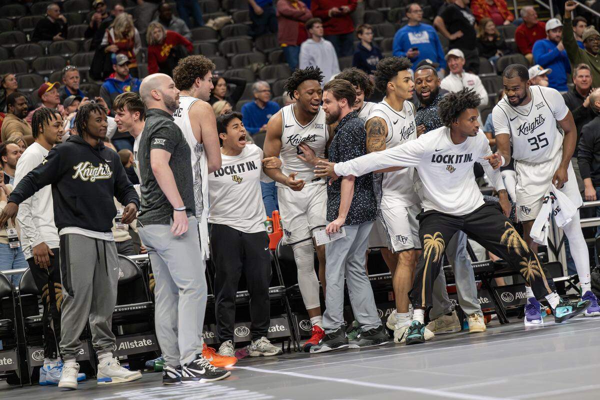 UCF players clear the bench after taking a one-point lead in overtime against Cincinnati during a Big 12 men's basketball tournament game at T-Mobile Center on Wednesday, March 11, 2026, in Kansas City.