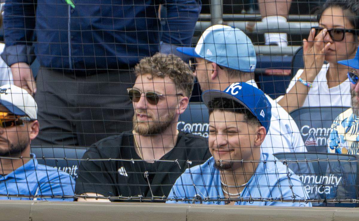 Kansas City Chiefs quarterback Patrick Mahomes, center, attends a home opening game between the Kansas City Royals and the Minnesota Twins at Kauffman Stadium on Monday, March 30, 2026, in Kansas City.