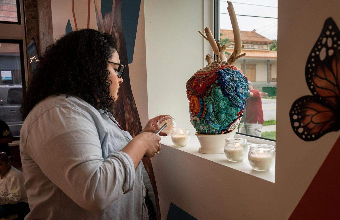 Selina Rios lights candles late in the evening as people gather at the Latinx Education Collaborative for the “Vigilia para nuestros niños” (Vigil for Our Children), in Kansas City on May 31, 2022.