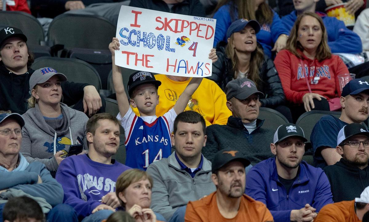 A Kansas fan holds up a sign during an NCAA college basketball game between Kansas and West Virginia in the second round of the Big 12 Conference tournament Thursday, March 9, 2023, in Kansas City.