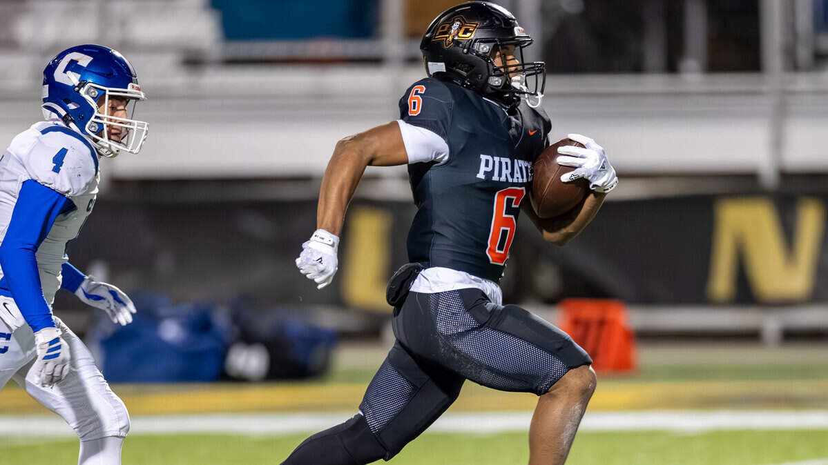 Platte County High School football player Tres Baskerville jets 66 yards for a touchdown during the Pirates’ 34-28 overtime victory over Carthage at Spratt Memorial Stadium in St. Joseph, Missouri on Friday, Dec. 5, 2025. With the win, Platte County earned consecutive Missouri Class 5 state football titles.