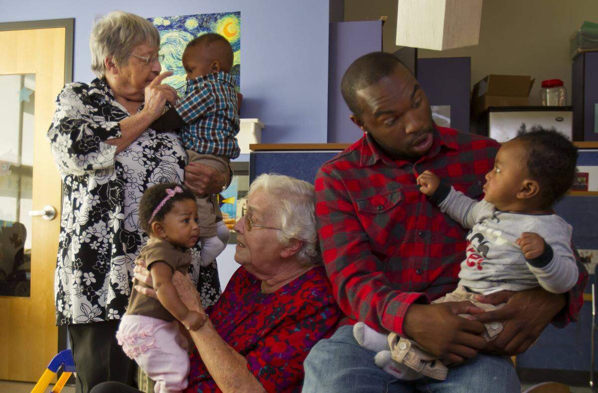 2011 file photo. Chris Waxter, then 23, second from right, was a regular at Operation Breakthrough having first come to the child-care center when he was eight years old. Operation Breakthrough was getting ready to host a reunion event on its 40th anniversary in 2011 for alumni like Waxter. Sister Berta Sailer, standing second from left, and Sister Corita Bussanmas, seated center, and Waxter were photographed in an playroom for infants at Operation Breakthrough.