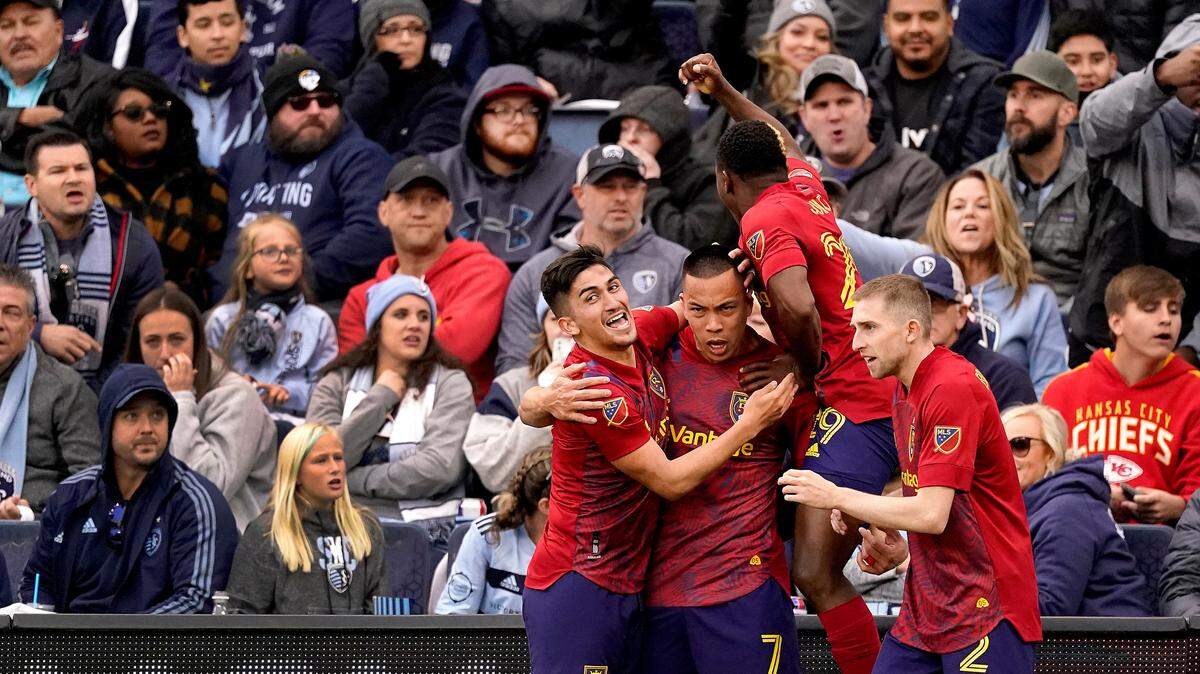 Real Salt Lake forward Bobby Wood (7) celebrates with teammates after scoring the winning goal during the second half of an MLS soccer match against Sporting Kansas City Sunday, Nov. 28, 2021, in Kansas City, Kan. Real Salt Lake won 2-1.(AP Photo/Charlie Riedel)