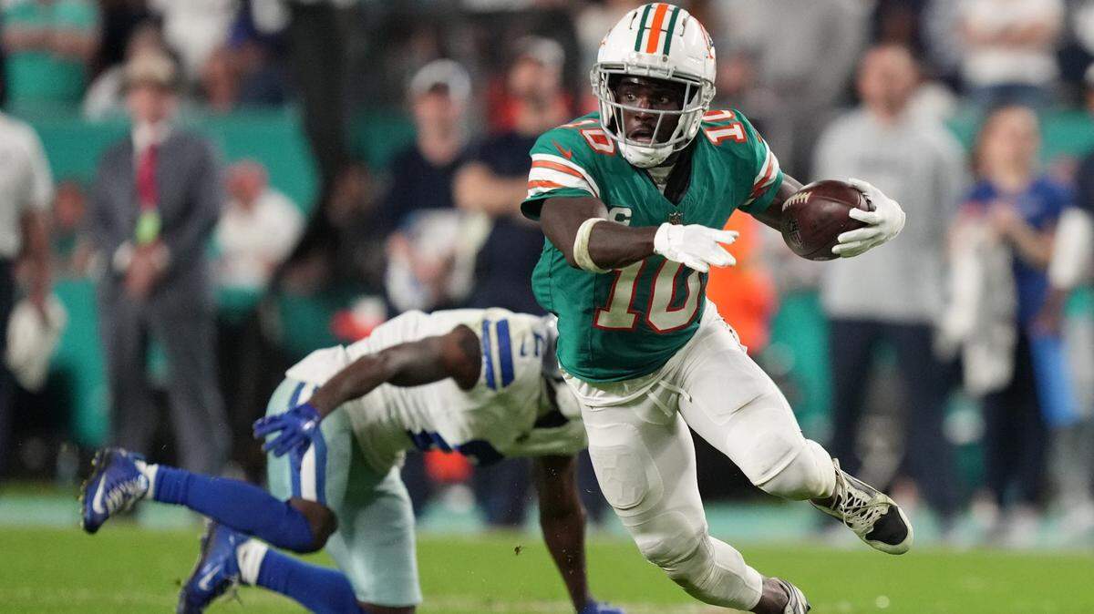 Miami Dolphins wide receiver Tyreek Hill (10) picks up a first down on the Dolphins final drive that lead to a game-winning field goal against the Dallas Cowboys during an NFL game at Hard Rock Stadium in Miami Gardens, Dec. 24, 2023.