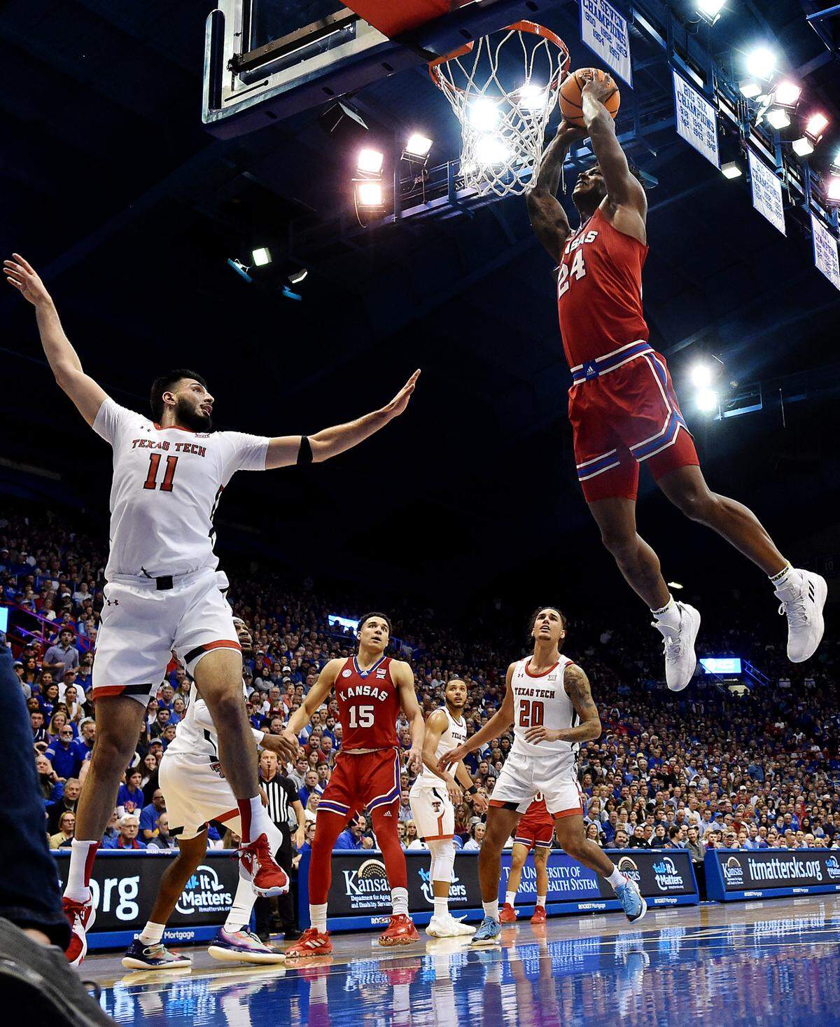 KU’s KJ Adams didn’t hold anything back when he took this pass and slammed it home in front of Texas Tech’s Fardaws Aimaq during the second half of Tuesday night’s Big 12 Conference game at Allen Fieldhouse. KU beat Texas Tech, 67-63 to clinch the Big 12 Conference regular season title
