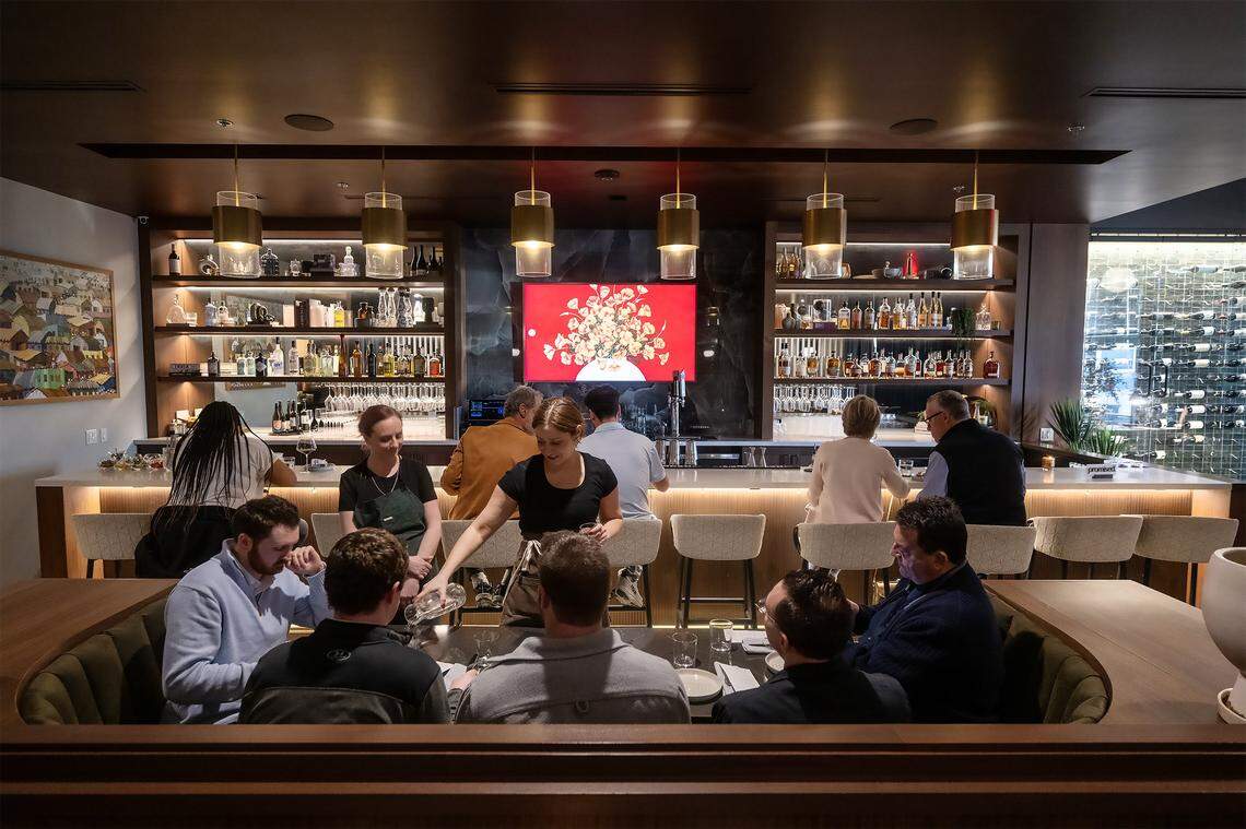 Customers sit at the bar and in a booth as staff attend to them at Of Course Kitchen & Co., 7753 W. 159th St. in Overland Park, on Wednesday, Feb. 25, 2026.