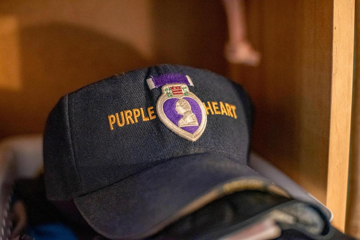 A Purple Heart cap rests on a shelf in the home of John Musgrave, who earned two of the medals for his service in Vietnam.