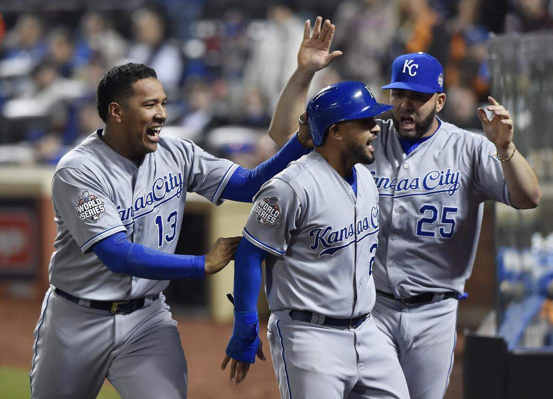 Kansas City Royals catcher Salvador Perez and designated hitter Kendrys Morales congratulated shortstop Christian Colon after Colon scored in the 12th inning during Game 5 of the World Series on Sunday, November 1, 2015 at Citi Field in New York.