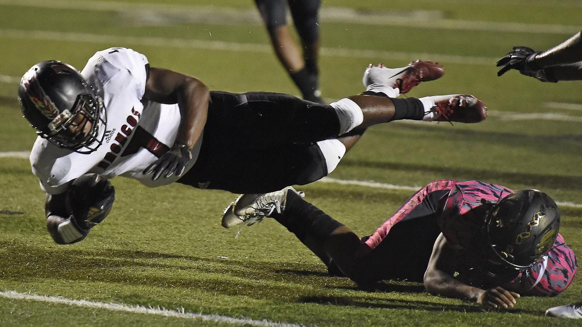Lee’s Summit North’s Ontario Russell dived into the end zone for a touchdown against Lee’s Summit at Lee’s Summit High School on Friday night.