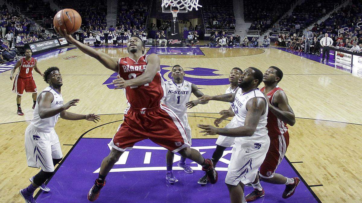 Bradley's Omari Grier gets past a group of Kansas State defenders to shoot during the first half of an NCAA college basketball game Tuesday, Dec. 9, 2014, in Manhattan, Kan. 