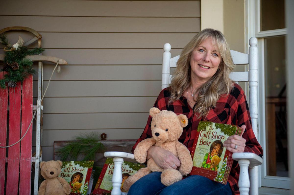 Phyllis Harris, author and illustrator of “The Gift Shop Bear,” sits outside her home in Raymore with the stuffed bear she used as the model for the art in her book.