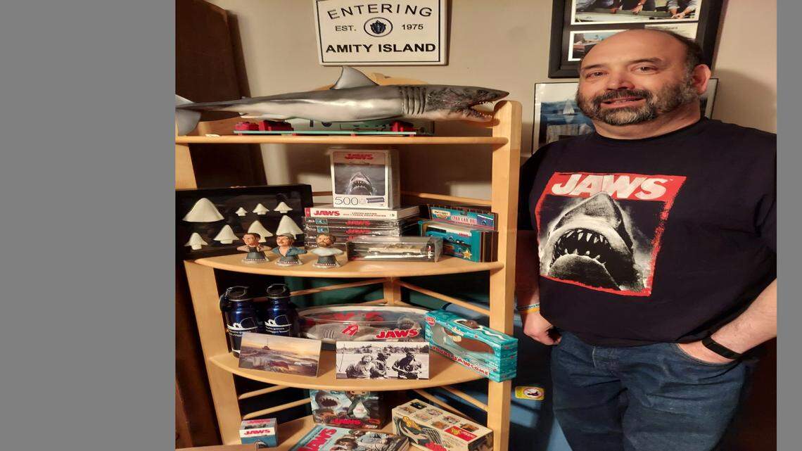 Lee’s Summit resident Michael Smith shows off his “Jaws” memorabilia collection. Smith recently updated a book on the making of the film.