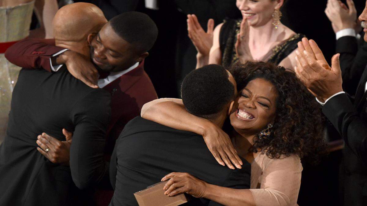 Oprah Winfrey, left, congratulates John Legend after he won the award for best original song in a feature film for “Glory” from “Selma" at the Oscars on Sunday, Feb. 22, 2015, at the Dolby Theatre in Los Angeles. 
