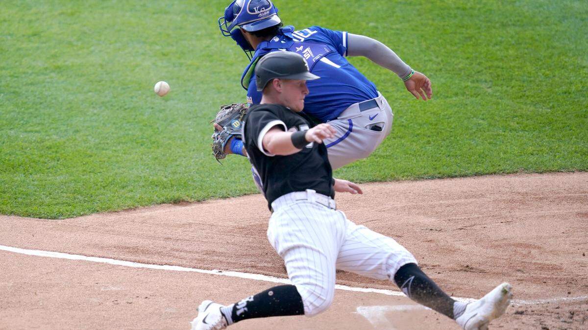 Chicago White Sox’s Andrew Vaughn scores behind Kansas City Royals catcher MJ Melendez during the first inning of a baseball game Wednesday, Aug. 3, 2022, in Chicago. (AP Photo/Charles Rex Arbogast)