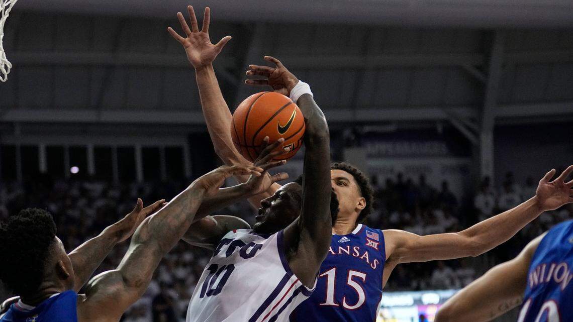 TCU guard Damion Baugh attempts to shoot as Kansas guard Kevin McCullar Jr. defends in the second half of a game on Feb. 20, 2023, in Fort Worth, Texas.
