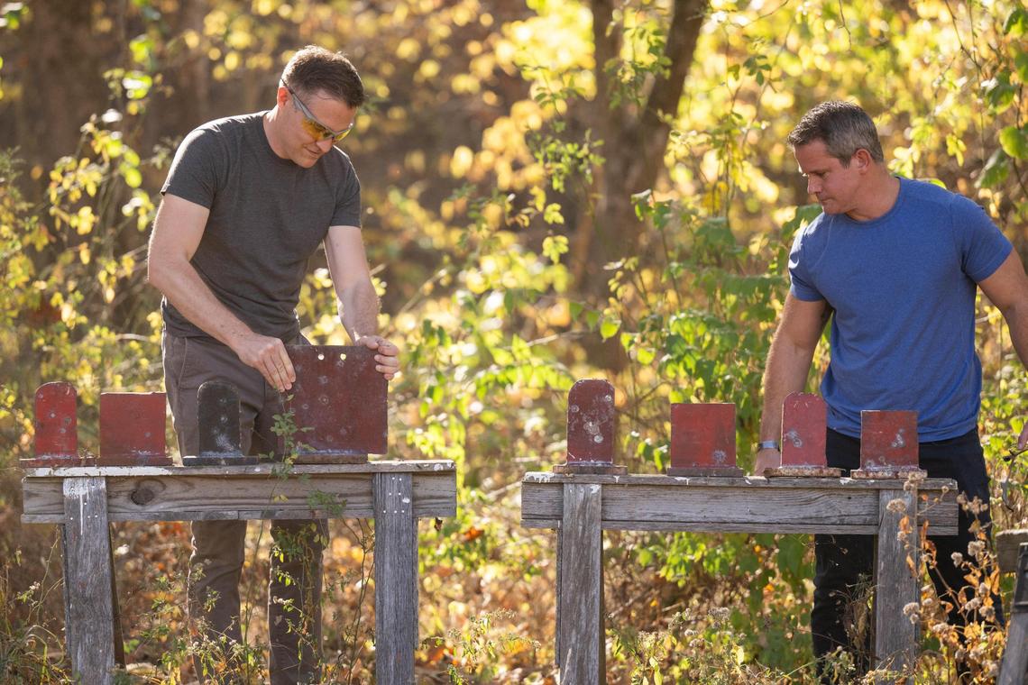 Democratic candidate for U.S. Senate Lucas Kunce and former Republican state representative Adam Kinzinger replace targets during a sport shooting campaign event Tuesday, Oct. 22, 2024 in Holt, Missouri.
