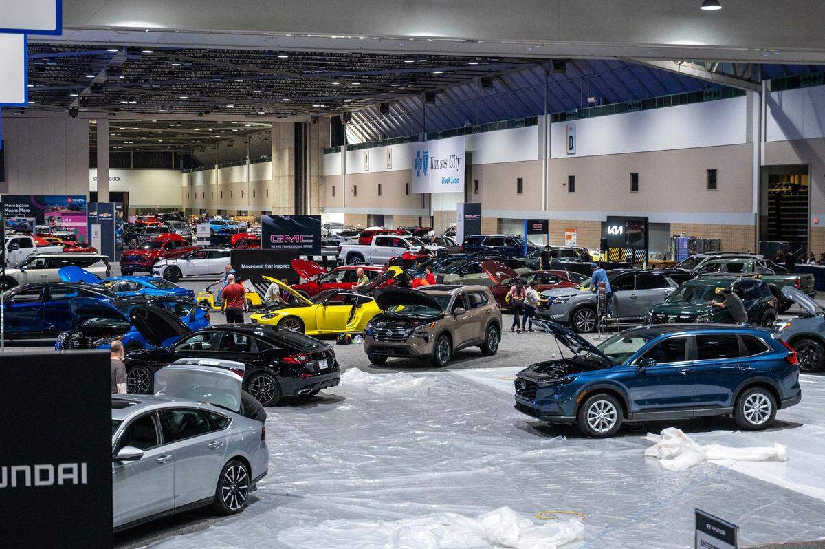 The floor in the exhibition hall at Bartle Hall fills with vehicles Wednesday, March 13, 2024, as the cars are driven in and set up for display for the Kansas City Auto Show.