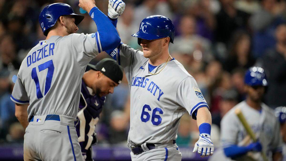 Kansas City Royals’ Hunter Dozier, left, congratulates pinch-hitter Ryan O’Hearn, who had hit a two-run home run off Colorado Rockies relief pitcher Carlos Estevez during the eighth inning of a baseball game Friday, May 13, 2022, in Denver.(AP Photo/David Zalubowski)