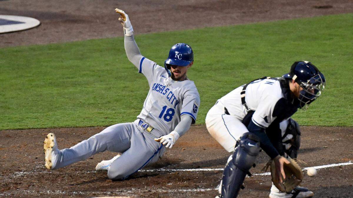 Kansas City Royals second baseman Cavan Biggio (18) scores a run as Tampa Bay Rays catcher Danny Jansen (19) catches the ball in the fifth inning at George M. Steinbrenner Field on April 30, 2025, in Tampa.