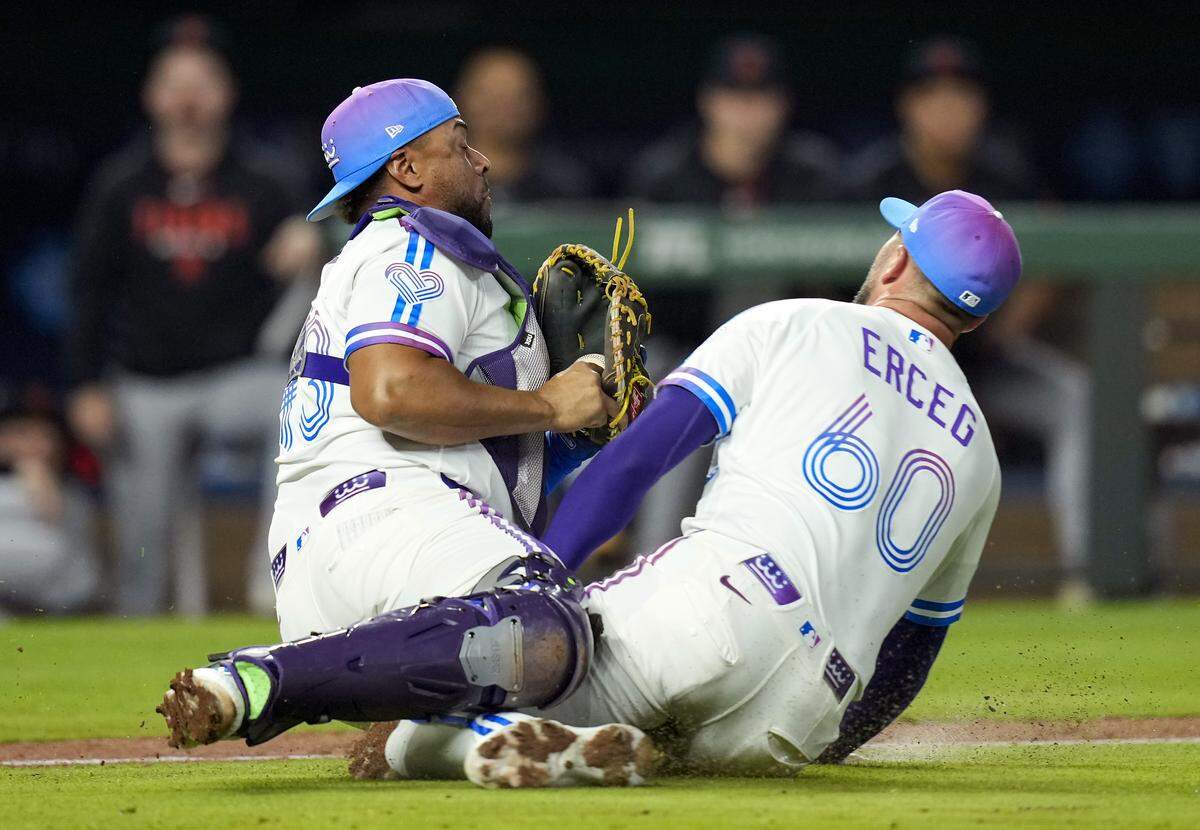 Royals catcher Elias Diaz, left, collides with closer Lucas Erceg after catching a popup bunt attempt during the ninth inning of a game against the Detroit Tigers at Kauffman Stadium in Kansas City on Friday, May 8, 2026.