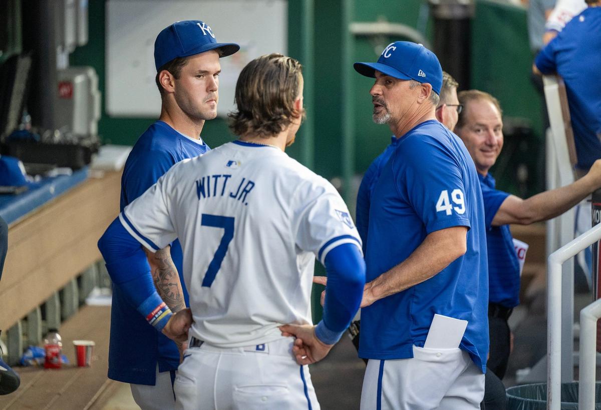 Kansas City Royals shortstop Bobby Witt Jr. (7) and pitcher Cole Ragans (55) talk with Kansas City Royals bench coach Paul Hoover (49) in between innings as the Royals took on the New York Yankees on Wednesday, June 12, 2024, at Kauffman Stadium.