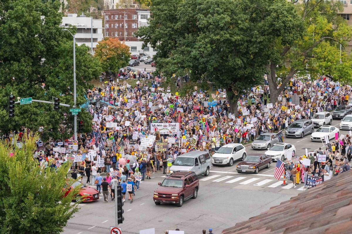 Demonstrators rally on Saturday, October 18, 2025, at Mill Creek Park in Kansas City as part of nationwide No Kings protests against the Trump administration. Protesters dressed up in costumes and brought signs showing their displeasure.