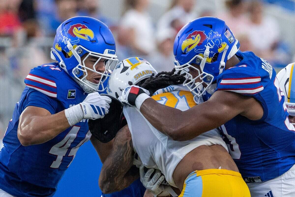 Kansas Jayhawks defenders tackle Long Island University Sharks running back Sam Slade (21) in the first half of the Jayhawks game vs. Long Island University Sharks at David Booth Memorial Stadium on Friday, September 4, 2026, in Lawrence.