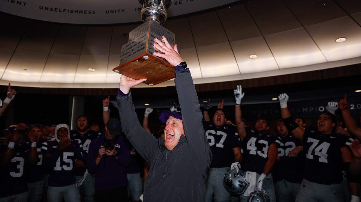 K-State Wildcats coach Chris Klieman lifts the Governor’s Cup celebrating a win over rival Kansas on Oct. 26, 2024.