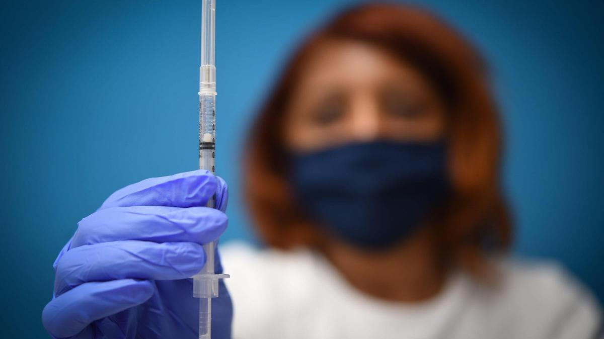 Talisha Johnson of KC CARE Health Center displayed a dose of the Pfizer COVID-19 vaccine at a walk-in vaccination clinic at the Northeast branch of the Kansas City Public Library on Thursday, Aug. 5, 2021, in Kansas City.