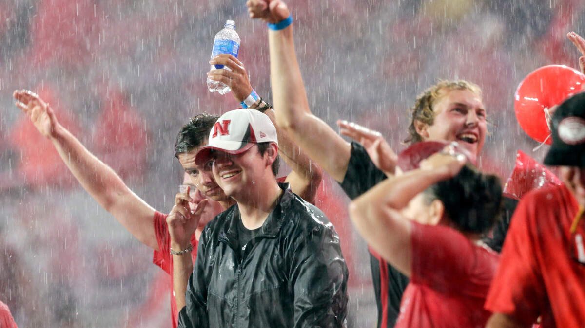Fans at Memorial Stadium stand in the pouring rain during a lightning and rain delay in the first half of an NCAA college football game between Nebraska and Akron, in Lincoln, Neb., Saturday, Sept. 1, 2018. (AP Photo/Nati Harnik)