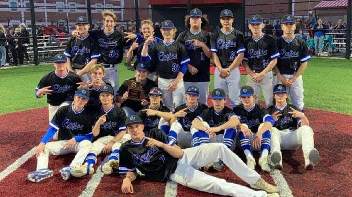 The Grain Valley baseball team poses with the district championship trophy the Eagles won last month.