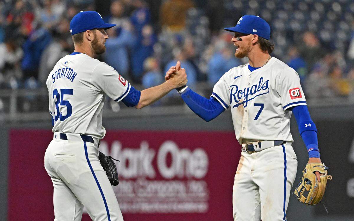 Kansas City Royals shortstop Bobby Witt Jr. (7) and pitcher Chris Stratton (35) celebrate after beating the Chicago White Sox at Kauffman Stadium on April 6, 2024.