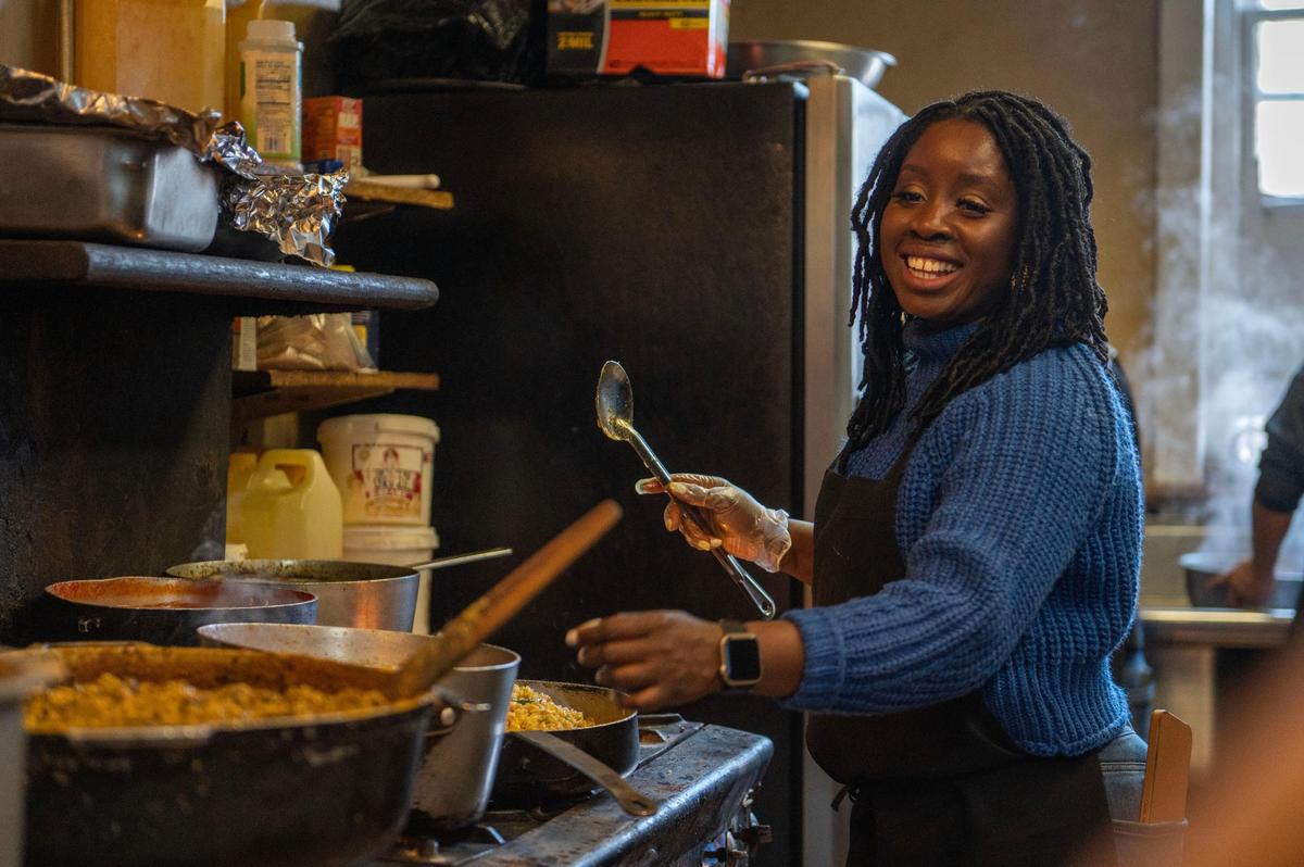 Fannie Gibson, owner of Fannie’s West African Cuisine, prepares an order of peanut butter soup. The spices she adds are a secret.