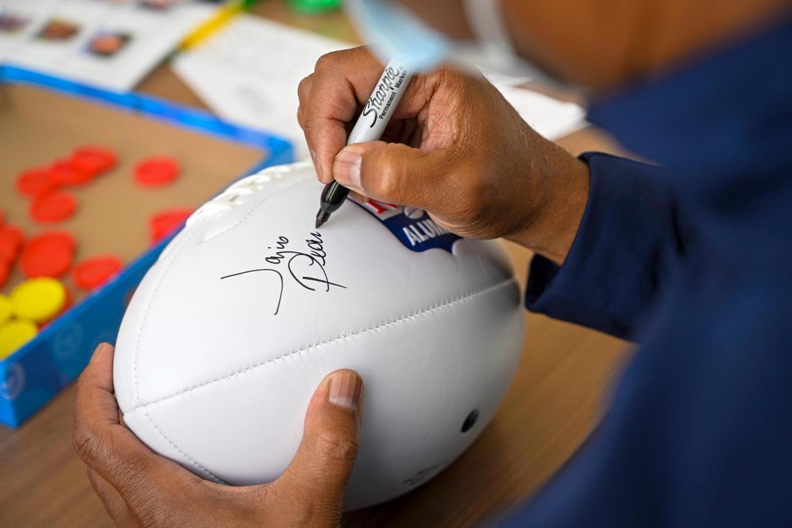 J.C. Pearson, who played with the Chiefs from 1986 to 1992, autographed a football for Children’s Mercy patient Kyler Burks, 17, of Jewell, Kansas.