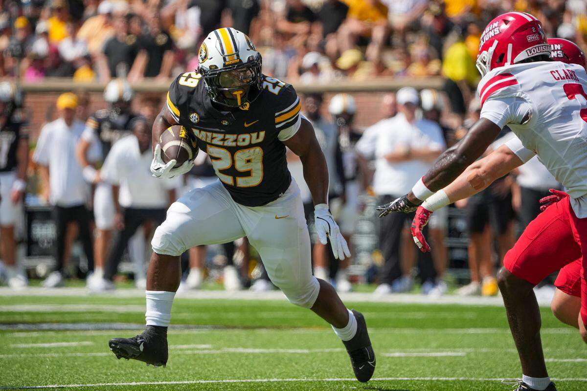 Missouri Tigers running back Ahmad Hardy (29) runs the ball as Louisiana-Lafayette Ragin’ Cajuns safety Jalen Clark (2) defends during the first half of the game at Faurot Field at Memorial Stadium on Sept. 13, 2025.