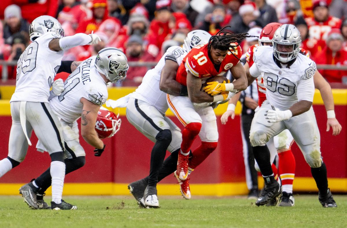 Las Vegas Raiders linebacker Divine Deablo (5) wraps up Kansas City Chiefs running back Isiah Pacheco (10) during an NFL football game on Monday, Dec. 25, 2023, at Arrowhead Stadium at GEHA Field in Kansas City.