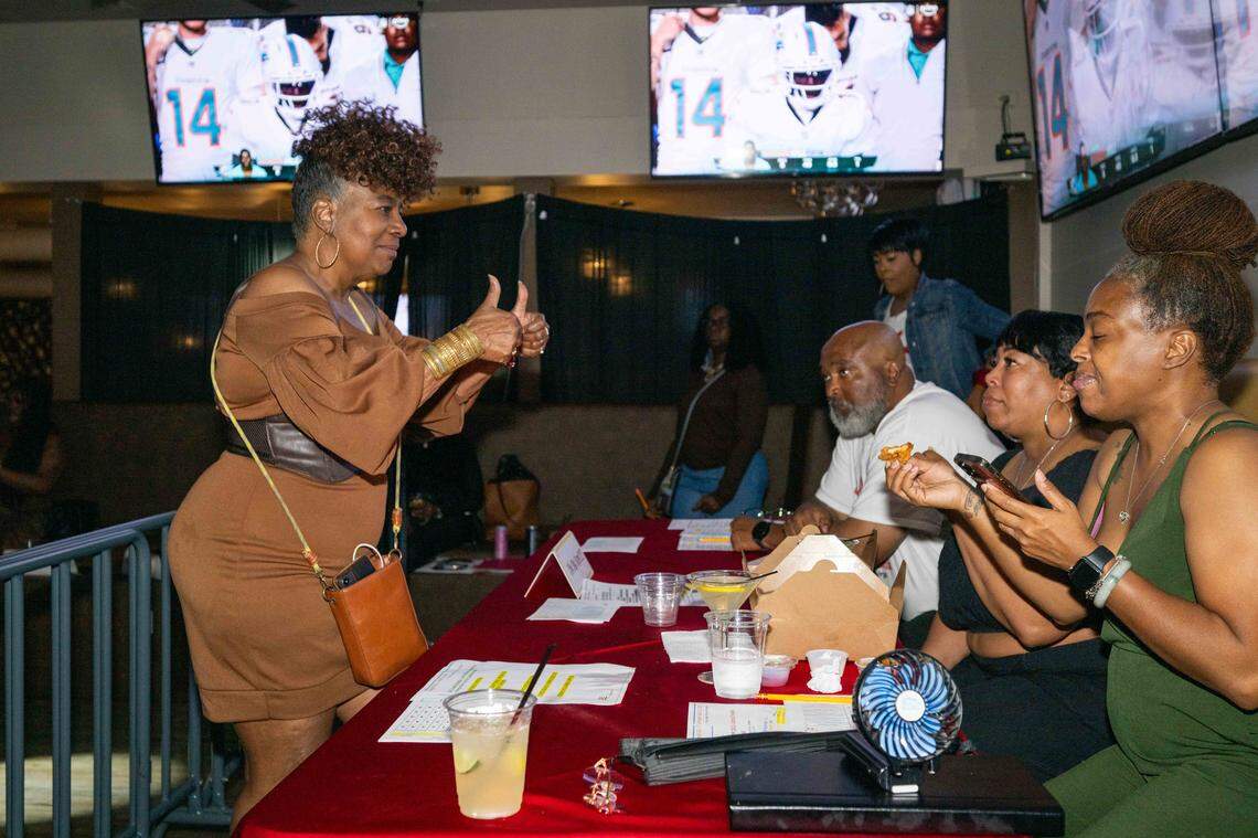 De Barker, the event organizer, speaks with judges at the preliminaries for The Big StepOff 2025, on Sept. 18, in Kansas City. Barker has played a major role in keeping the Kansas City two-step community alive.