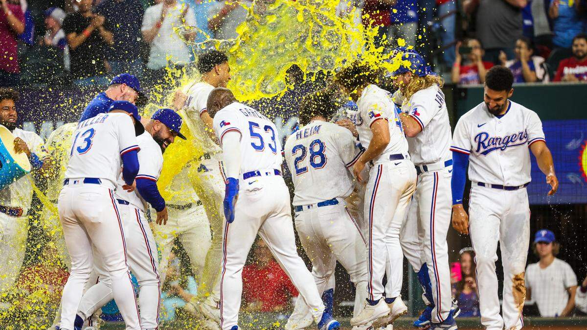 Texas Rangers catcher Jonah Heim (28) celebrates with teammates after hitting a walk-off three run home run during the tenth inning against the Kansas City Royals at Globe Life Field on April 11, 2023.