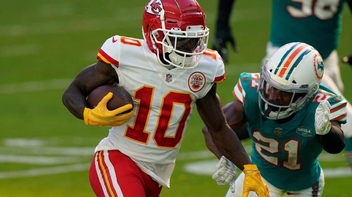 Kansas City Chiefs wide receiver Tyreek Hill (10) runs for a touchdown as Miami Dolphins free safety Eric Rowe (21) attempt to tackle, during the first half of an NFL football game, Sunday, Dec. 13, 2020, in Miami Gardens, Fla. (AP Photo/Lynne Sladky)