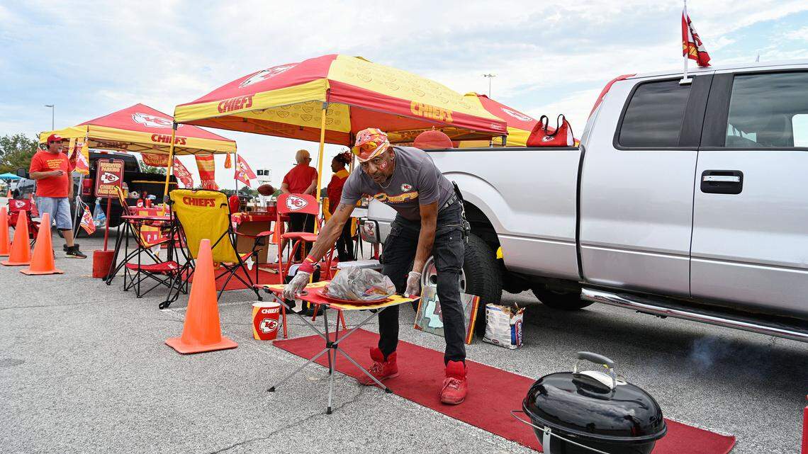 Joseph G. Patterson of Kansas City, gets food cooking at his tailgate setup prior to the Chiefs preseason game vs. the Chicago Bears. Patterson has a designated spot that he keeps for every game for decades.