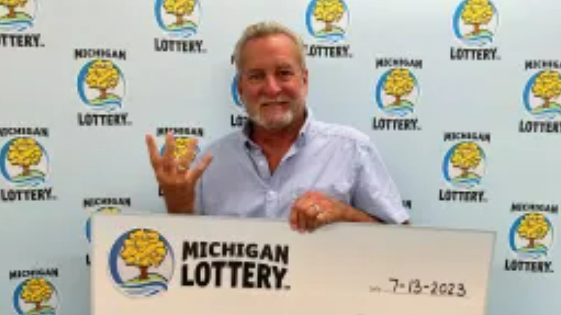 John Sancrant with his oversized check.