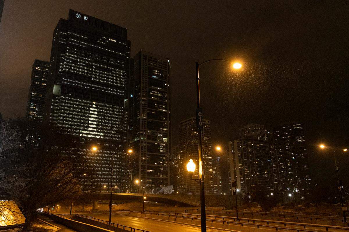The Blue Cross Blue Shield building arranges it lights to be a candle, during a National COVID-19 memorial, Tuesday, Jan. 19, 2021.